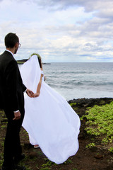 following bride at the sea side in hawaii