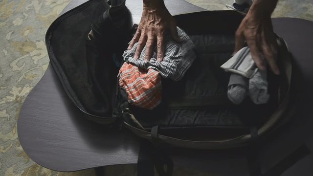 man packing suitcase