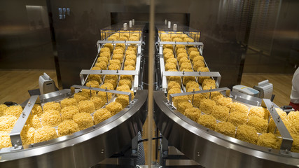 Instant noodles on conveyor belt in production process