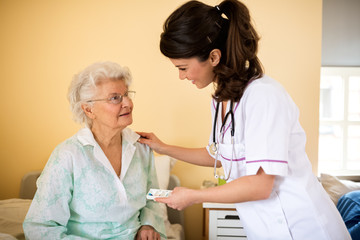 Old senior woman waiting nurse to bring drogs to her