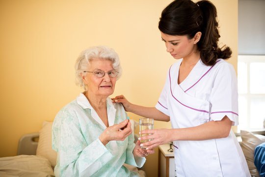 Senior old woman and nurse at nursing home