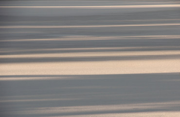 Shadows from trees on a frozen lake