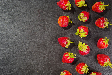 strawberries on stone background, delicious first class organic fruit as a concept of summer vitamins