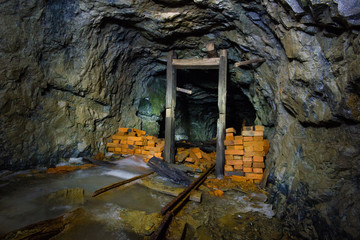 Underground abandoned ore mine shaft tunnel gallery with blocks