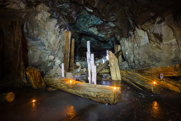 Underground abandoned ore mine shaft tunnel gallery with ice stalactites and stalagmites