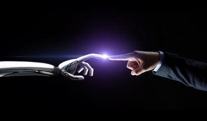 robot and human hand connecting fingers