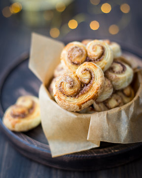 Cookies, curlicues, pretzels of puff pastry with sugar and cinnamon