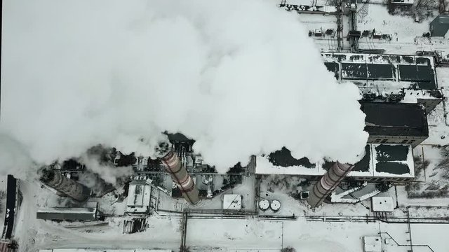 Aerial winter view of smoking industrial chimneys. Smoking power plant.