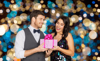 happy couple with gift box at birthday party