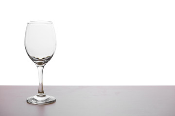 Glass of wine on the wooden table in white background or isolated