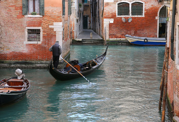 Fototapeta na wymiar Venice Italy the water way with gondola and a man