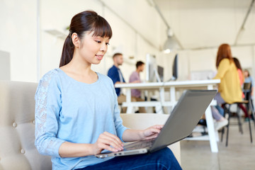 Fototapeta premium happy asian woman with laptop working at office