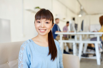 happy creative female worker at office