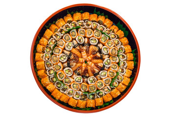 different types of sushi are stacked on a round dish on a white background. A variety of Japanese sushi buns.
