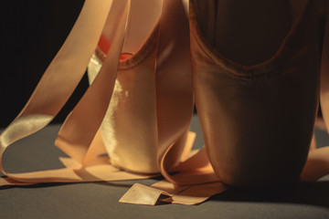 Ballet dance shoes on dark background