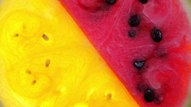 Red and yellow watermelon closeup rotating in 4K. Refreshing and juicy healthy fruit. Top view.
