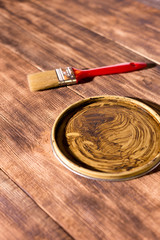 brush and jar cover on wooden background