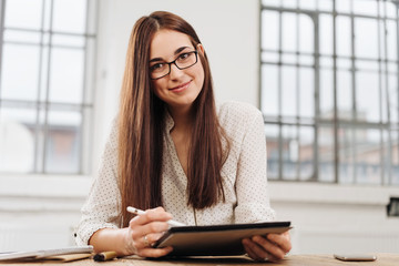 Young smiling woman with digital tablet