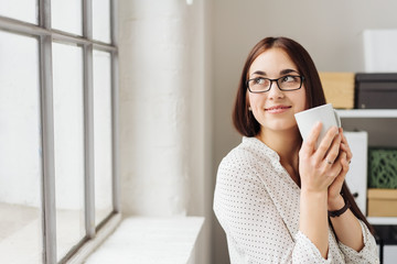 Smiling businesswoman enjoying her coffee break