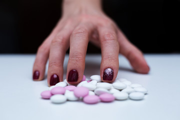 Depression and problem. Hand surrounded by many pills.