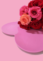 Bouquet of red and pink roses over pink heart