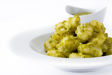 Gnocchi with pesto sauce in plate isolated on white background

