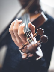 A young man is playing a violin.
