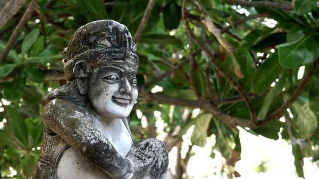 close up of a stone statue at kuta beach, bali