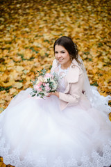 Fototapeta na wymiar happy bride on autumn forest. young beauty bride with big eye