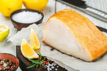 Salted white fish with lemon, rosemary and spices salt and pepper.  Butterfish. Halibut