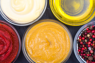 Set of sauces and spices on black background