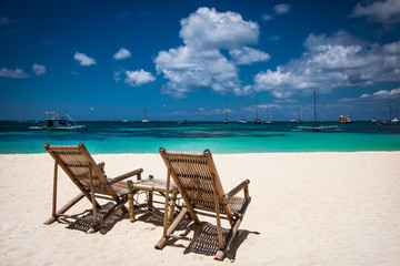 Tropical vacation on white sand beach with sun and blue sky at Boracay, Philippines.