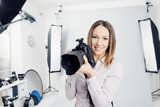 Young female photographer in the studio