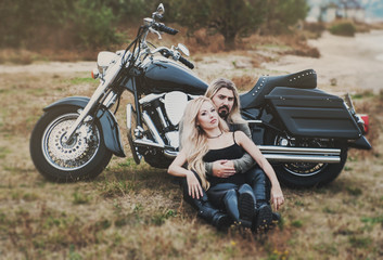 Fototapeta na wymiar Couple outdoor with a motorcycle 