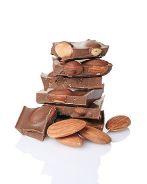 Close-up pieces of milk chocolate bar with whole almonds