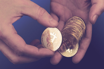 closeup of hands counting bitcoins