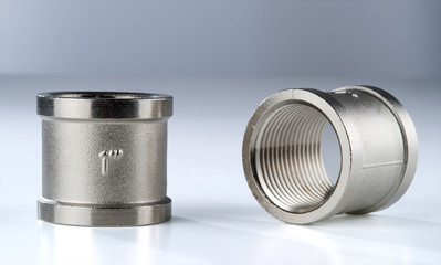 Two regular couplings of white metal with internal thread 1 inch.