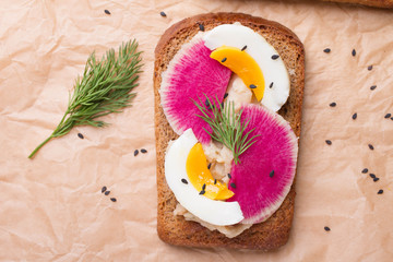 Open sandwiches with bean paste, egg, radish, sesame, dill. Concept of healthy eating or vegetarian food. Healthy food for vegan