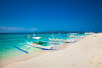 Fototapeta na wymiar Traditional boat that do a island hopping in the beautiful Puka Beach Boracay. Philippines