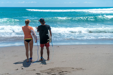 Surf couple on a beach