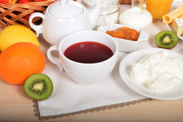 creamy white cream cheese with fruit sweet tea and kiwi orange and lemon with warm milk for a sweet breakfast for children