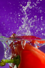 Fototapeta na wymiar colorful sweet pepper drops in water