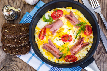 Breakfast for the family. Omelette with sausages