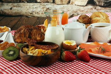 breakfast on table with waffles, croissants, coffe and juice