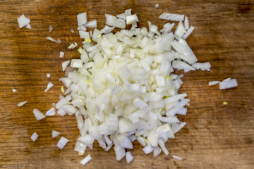 Crumbled white onion on a wooden board