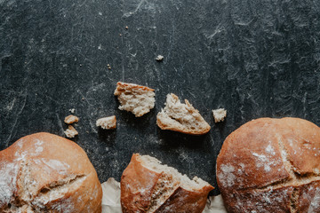 Traditional irish soda bread with packing paper on black stone