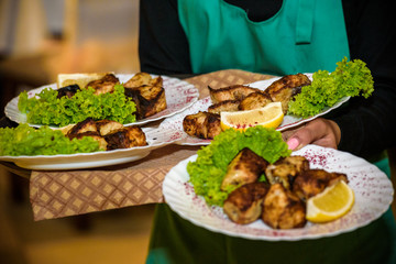 Waiter holding plate with tasty mussels, close up view