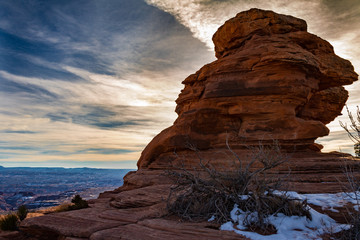 Gorgeous sunset on a rock formation in Canyonlands National Park in the winter with snow in Moab Utah USA.