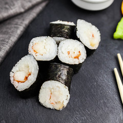 Japanese sushi rolls maki on the graphite board