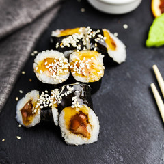 Japanese sushi rolls maki on the graphite board